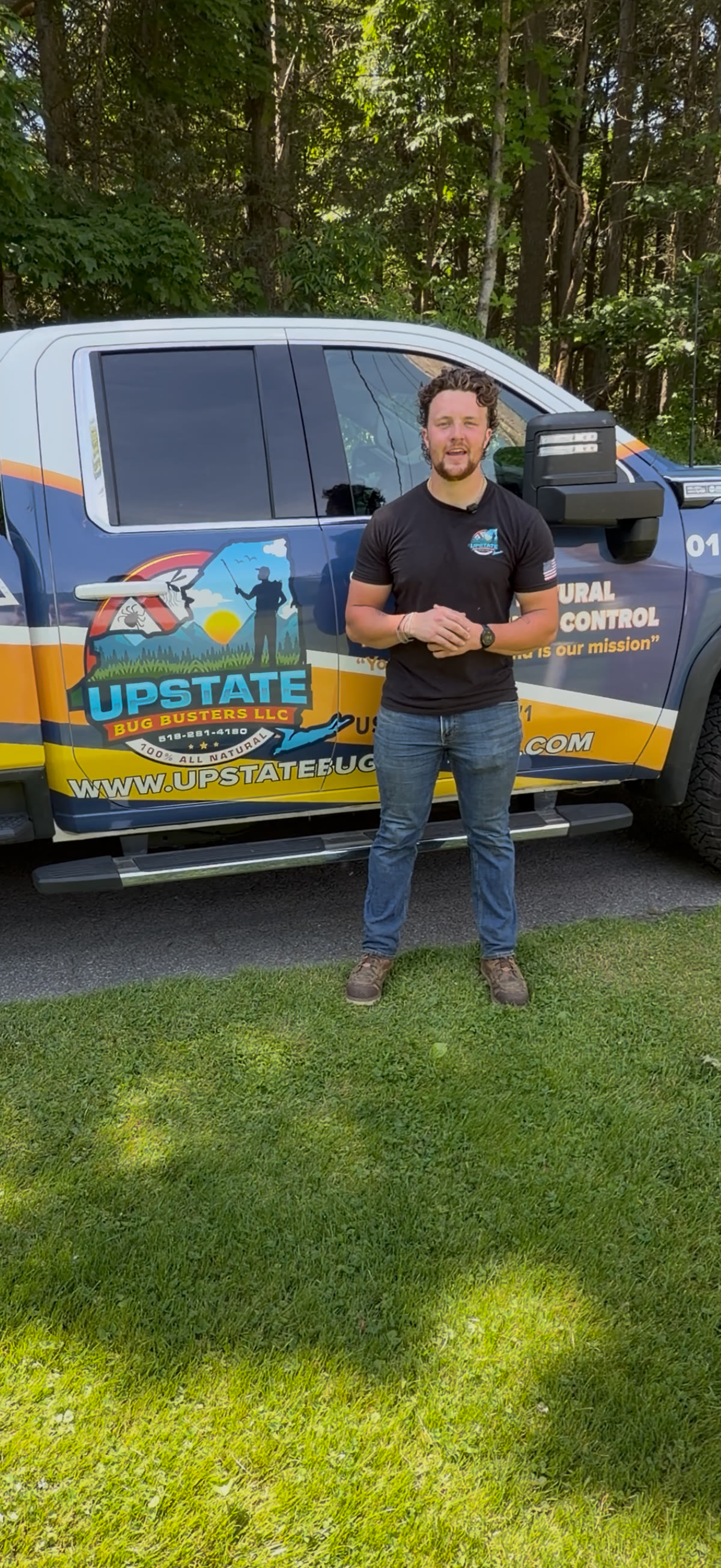Blake Mahieu standing beside an Upstate Bug Busters truck
